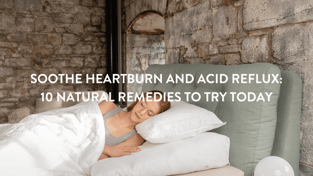 Person lying in bed on a Putnams pillow and bed wedge to help with heartburn and acid reflux. The bed has white linen with a teal headboard against a stone wall