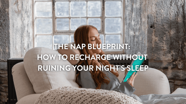 Person sitting on a sofa reading a book just about to have a nap