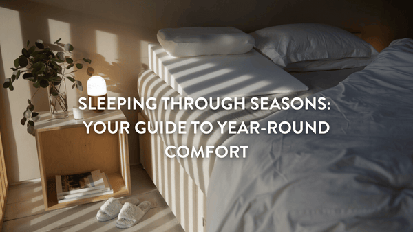 Empty double bed with sunlight casting a shadow on the white sheets