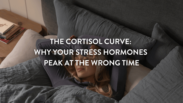 Person waking up in a double bed with arms raised