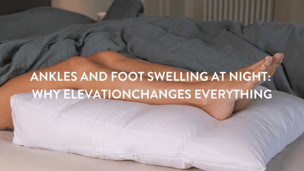 Person lying on a double bed elevating their legs and ankles to relieve swelling on a Putnams bed wedge pillow 
