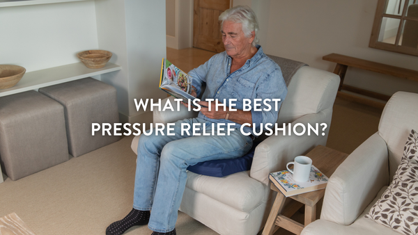 Person sitting on a Putnams pressure relief cushion on an armchair in a living room environment