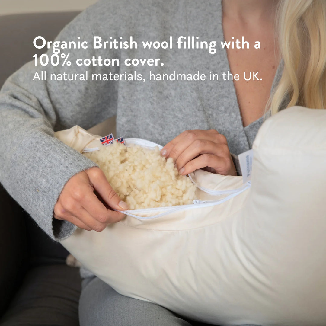 Organic British wool Nursing Pillow - Bottle & Breastfeeding Pillow with unbleached 100% cotton cover and visible zip, placed on a bed OEKOTEX standard 100 natural plastic free